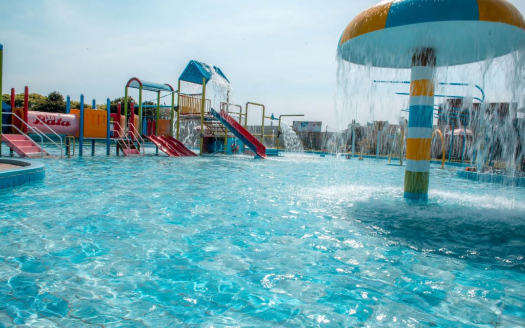 A vibrant water park featuring thrilling slides and water slides, offering endless fun and excitement.