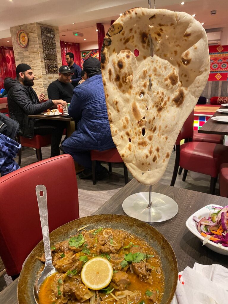 A plate of food with a large pita bread on it, ready to be enjoyed.